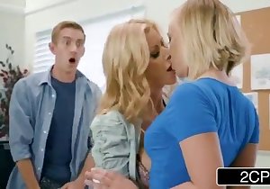 Two blond-haired women sharing a huge dick